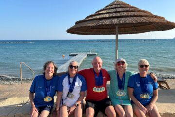 Masters swimmers display their medals after Cyprus swim meet