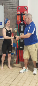 Spencer swimmer recieving a trophy 