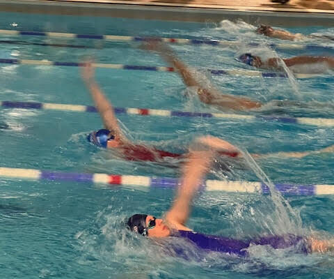 masters swimmer in backstroke race
