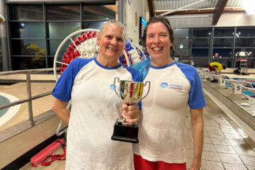 Masters swimmers with trophy