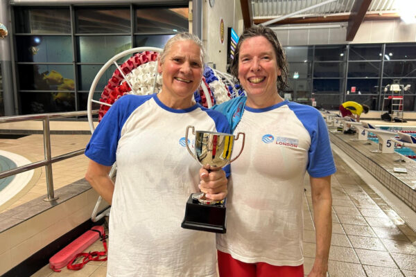 Masters swimmers with trophy